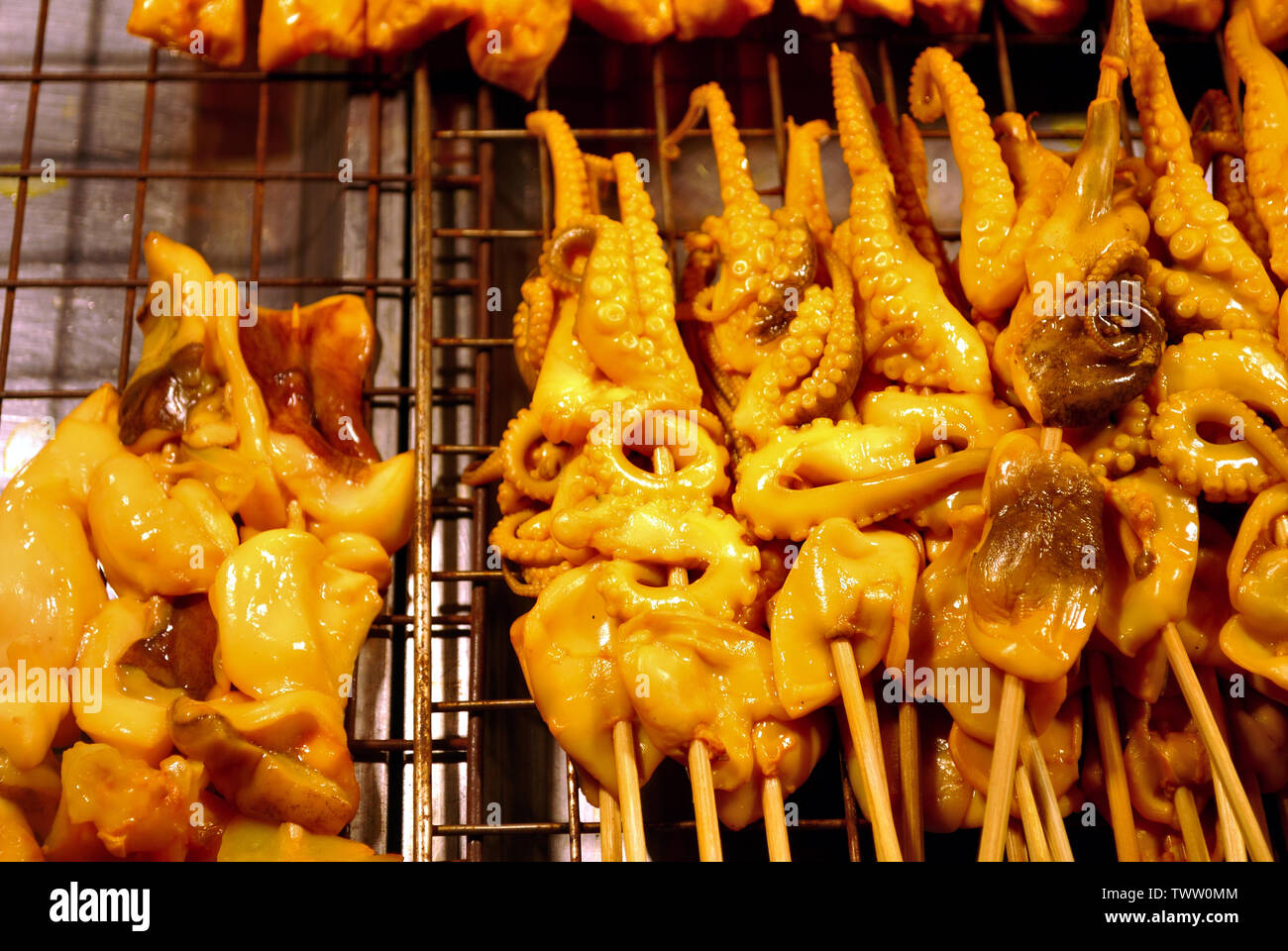 Squid marinated in the side dishes of the shop, placed on the tray, ready  for sale and grill service, waiting for customers to choose Stock Photo -  Alamy
