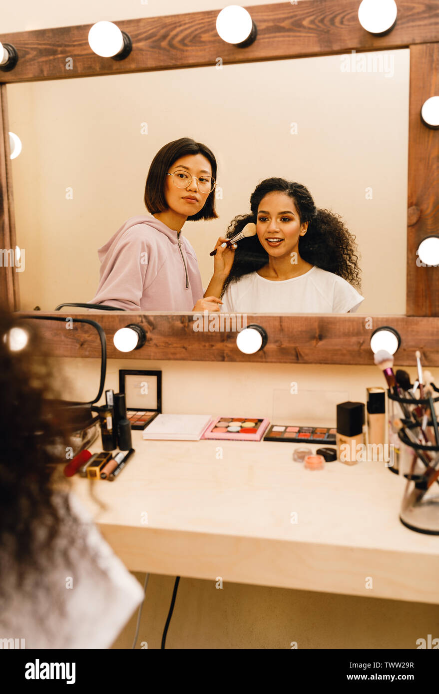 Two People In Dressing Room Looking At Mirror Stock Photo