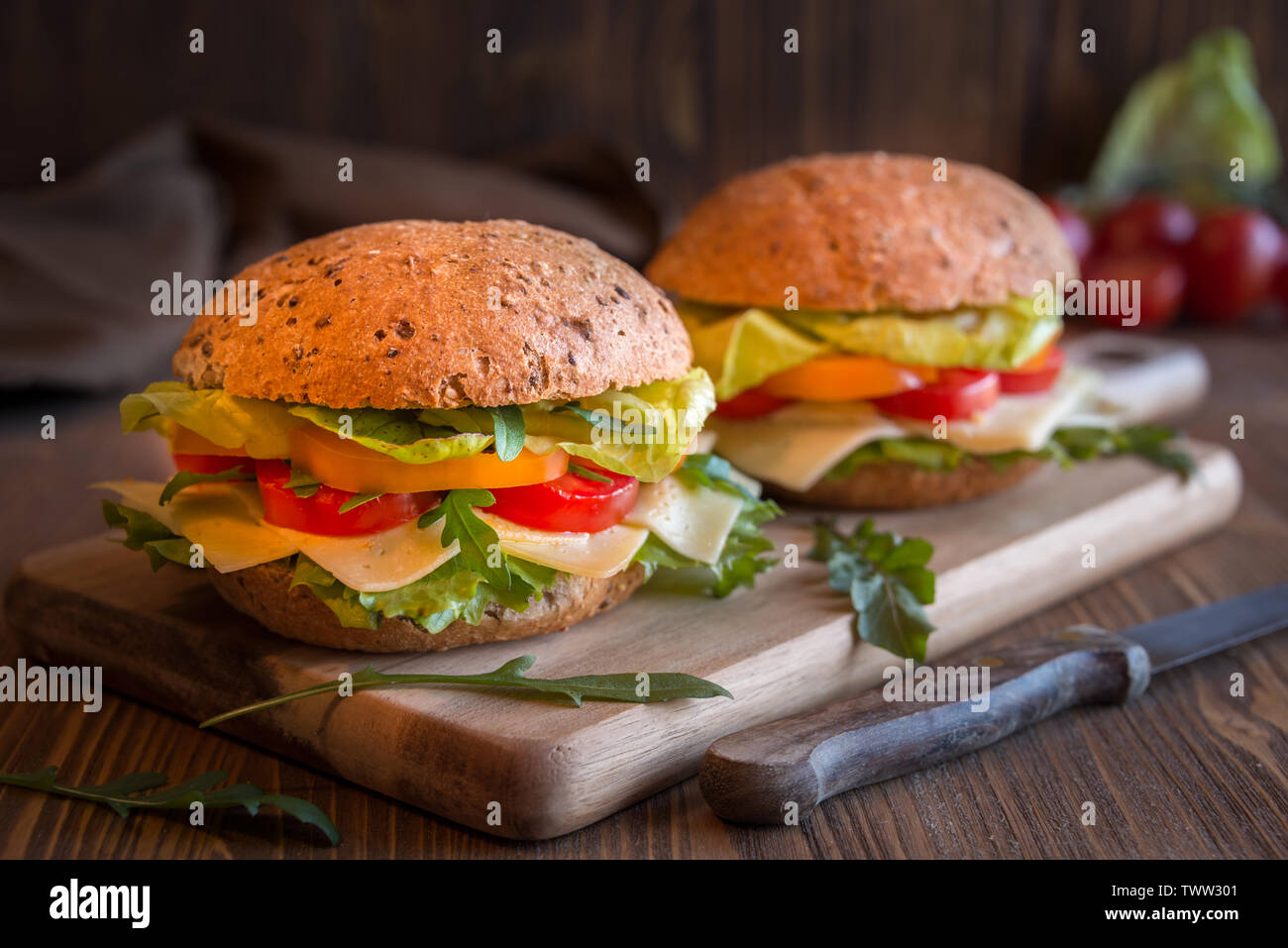 Vegetarian sandwiches with cheese, lettuce, vegetables and arugola on dark background Stock Photo