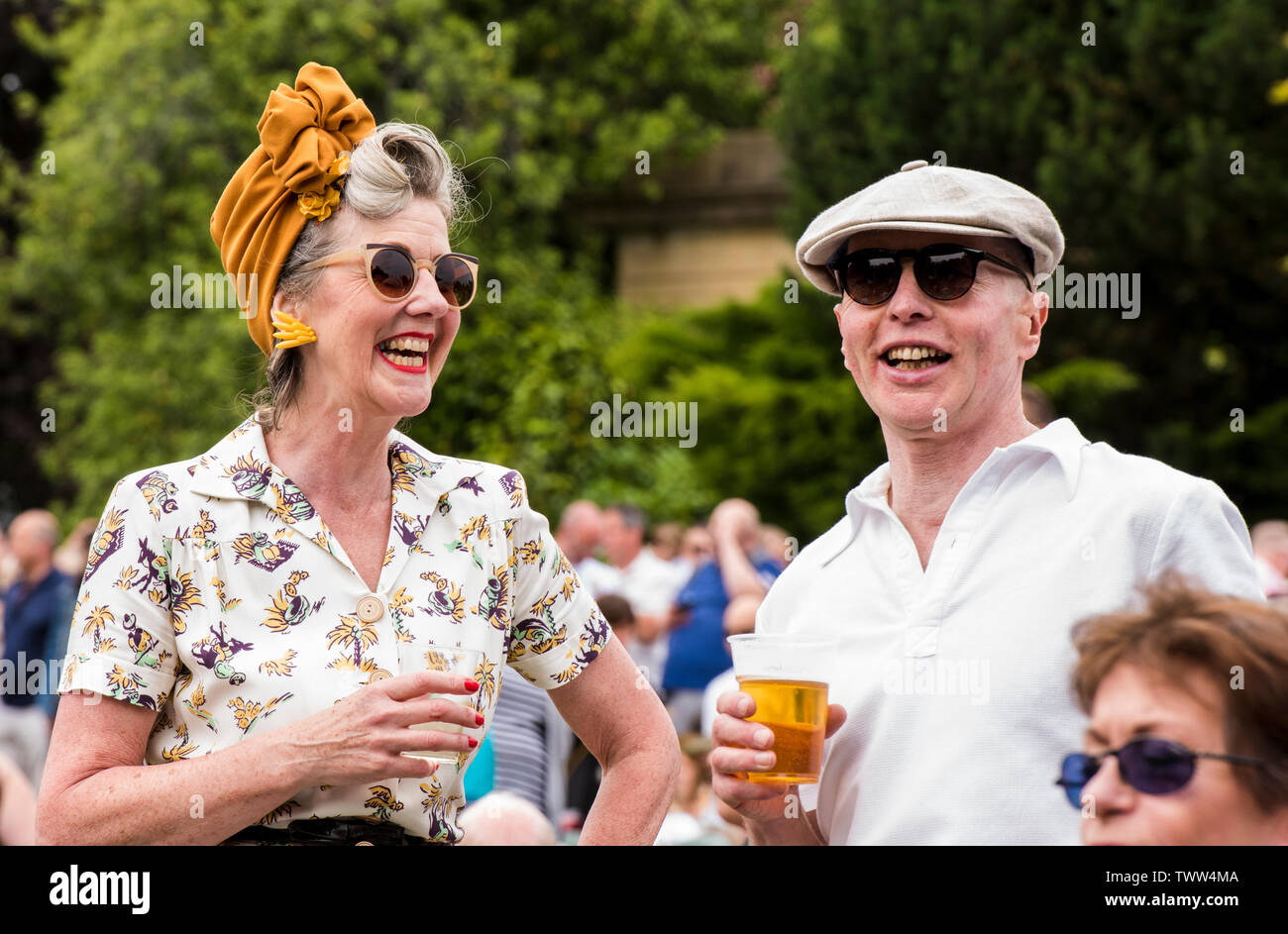 Couple wearing 1940s clothing in Valley Gardens on 1940s Day, Harrogate, England, UK, 23rd June 2019. Stock Photo