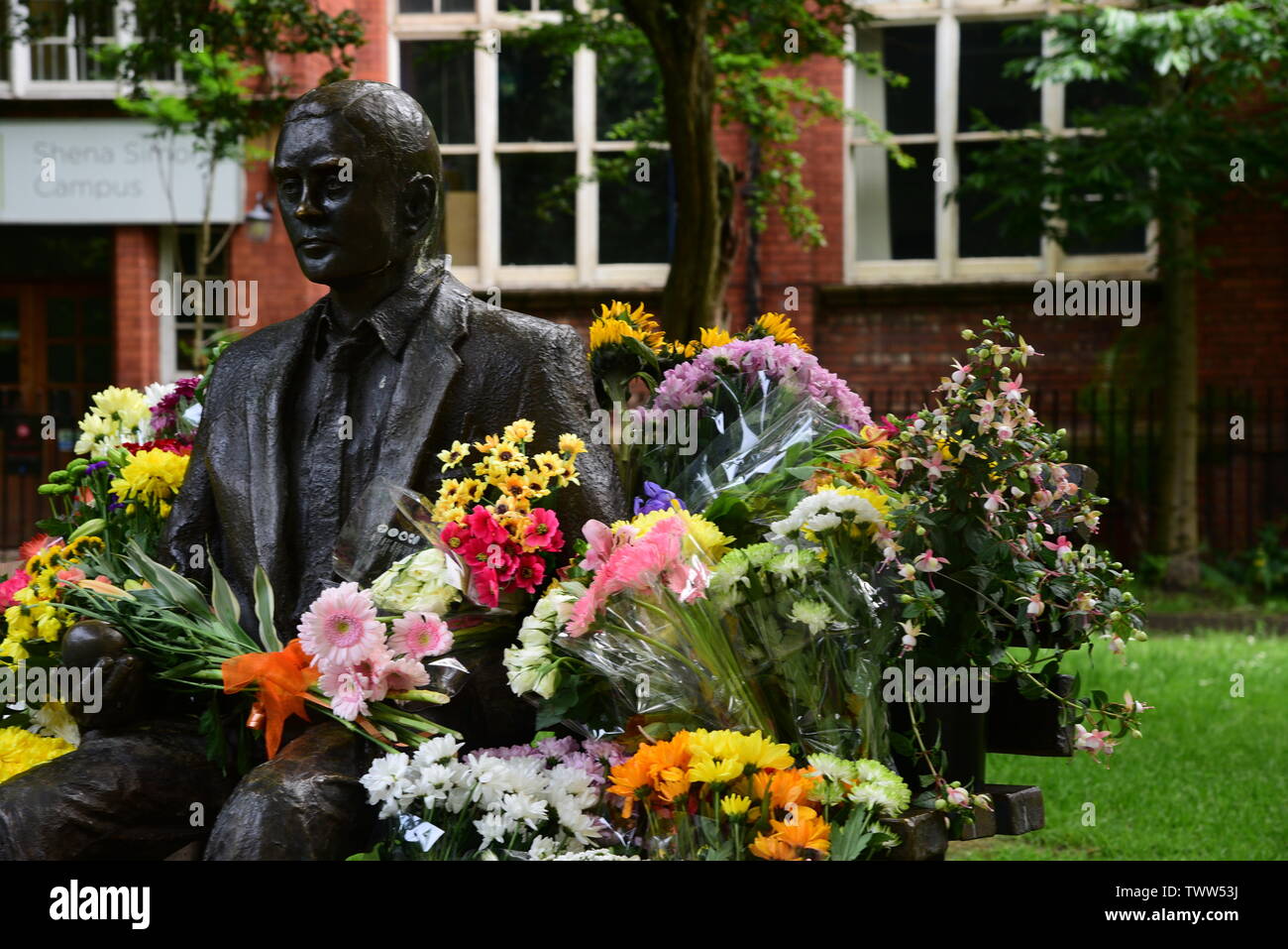 Alan Turing statue with flowers Stock Photo
