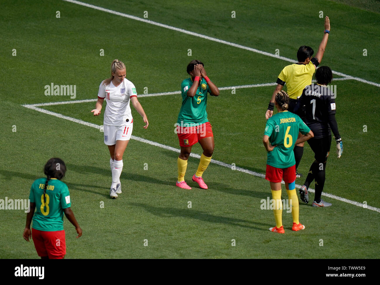 Match referee Qin Liang (second right) awards a free-kick to England in the penalty area after a back pass by Cameroon's Augustine Ejangue (5) during the FIFA Women's World Cup, round of Sixteen match at State du Hainaut, Valenciennes. Stock Photo