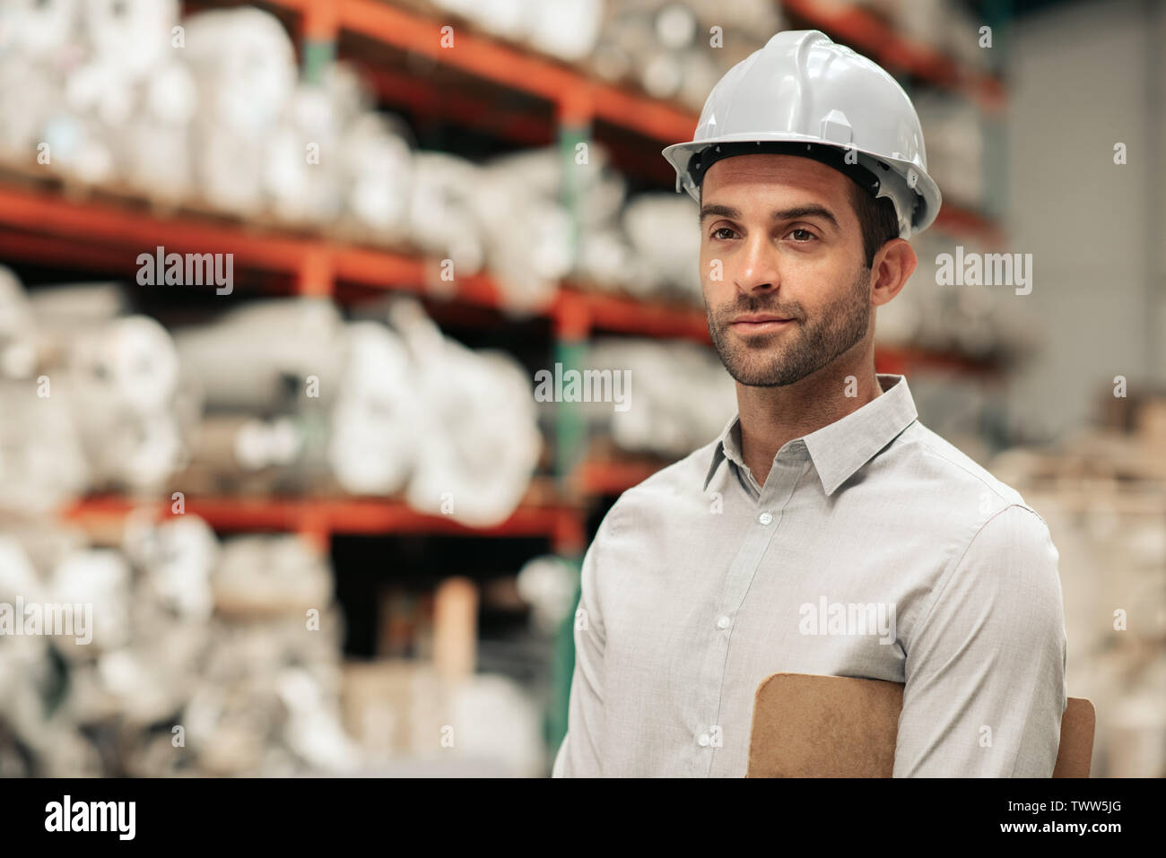 Foreman wearing a hard hat on his warehouse floor Stock Photo Alamy