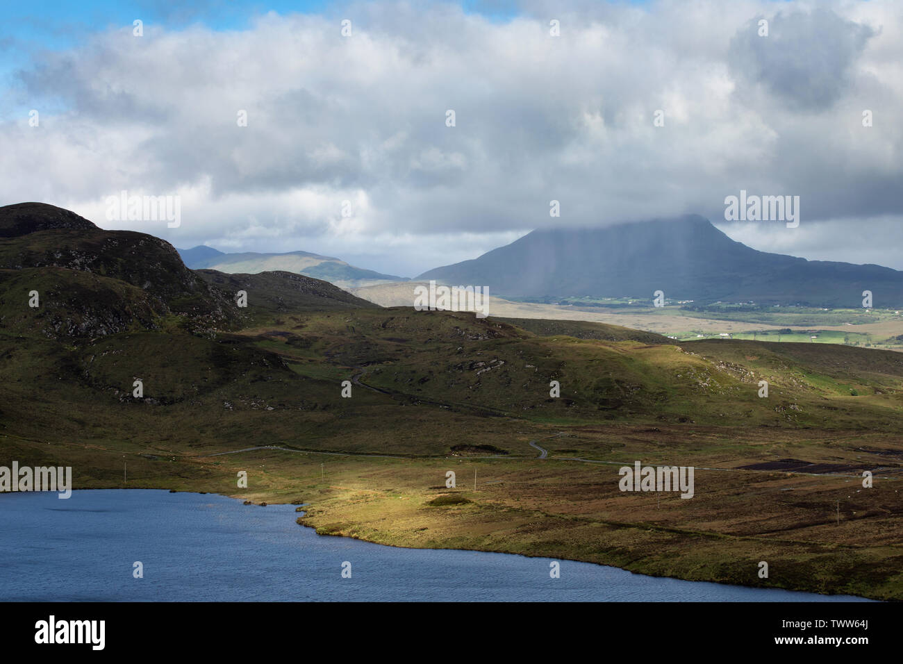 Dappled light rakes across the scenic Irish Landscape in County Donegal Ireland Stock Photo