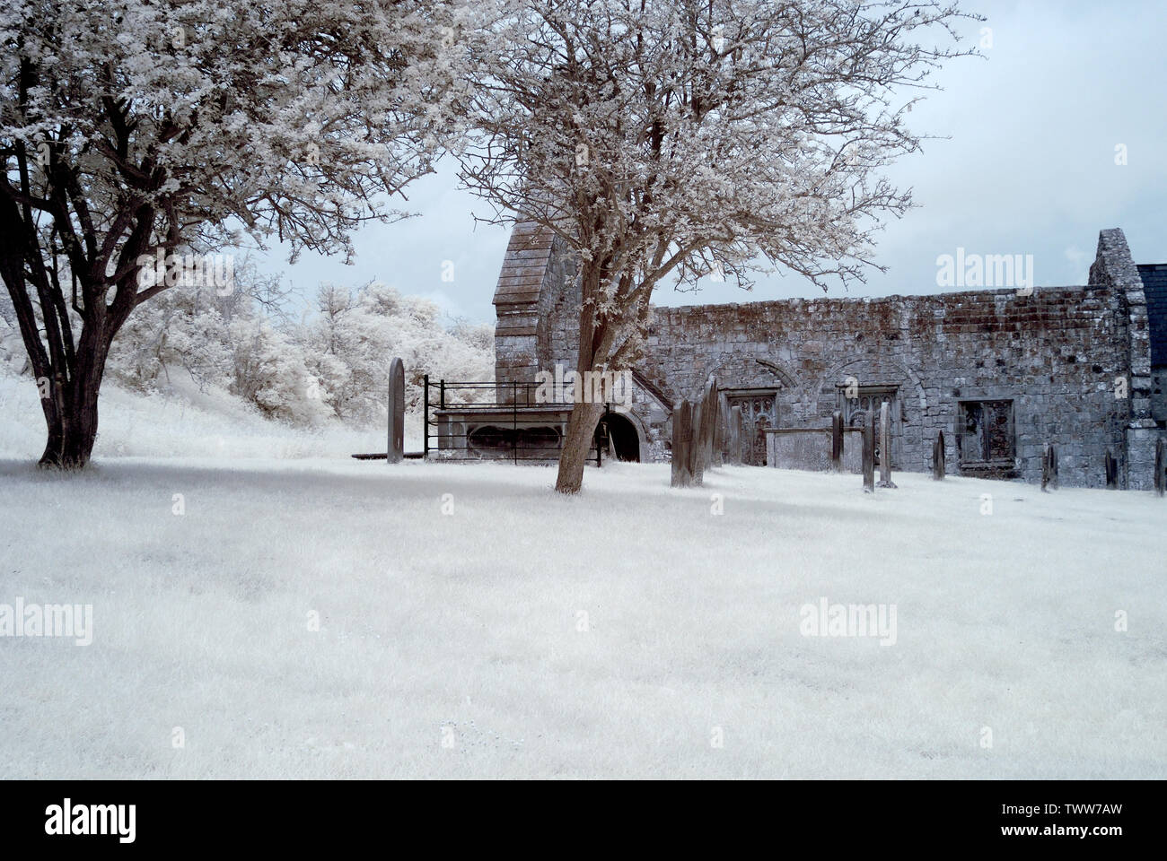 Infrared Image of ruined medieval church with gravestones Stock Photo
