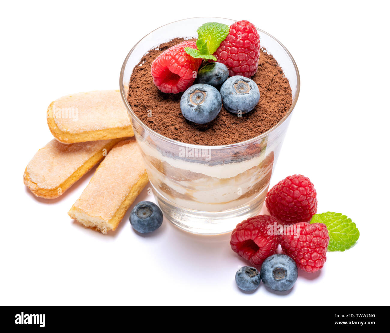 Classic tiramisu dessert with blueberries and raspberries in a glass ...