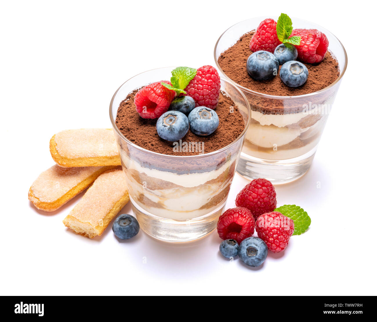 Classic tiramisu dessert with blueberries and raspberries in a glass ...