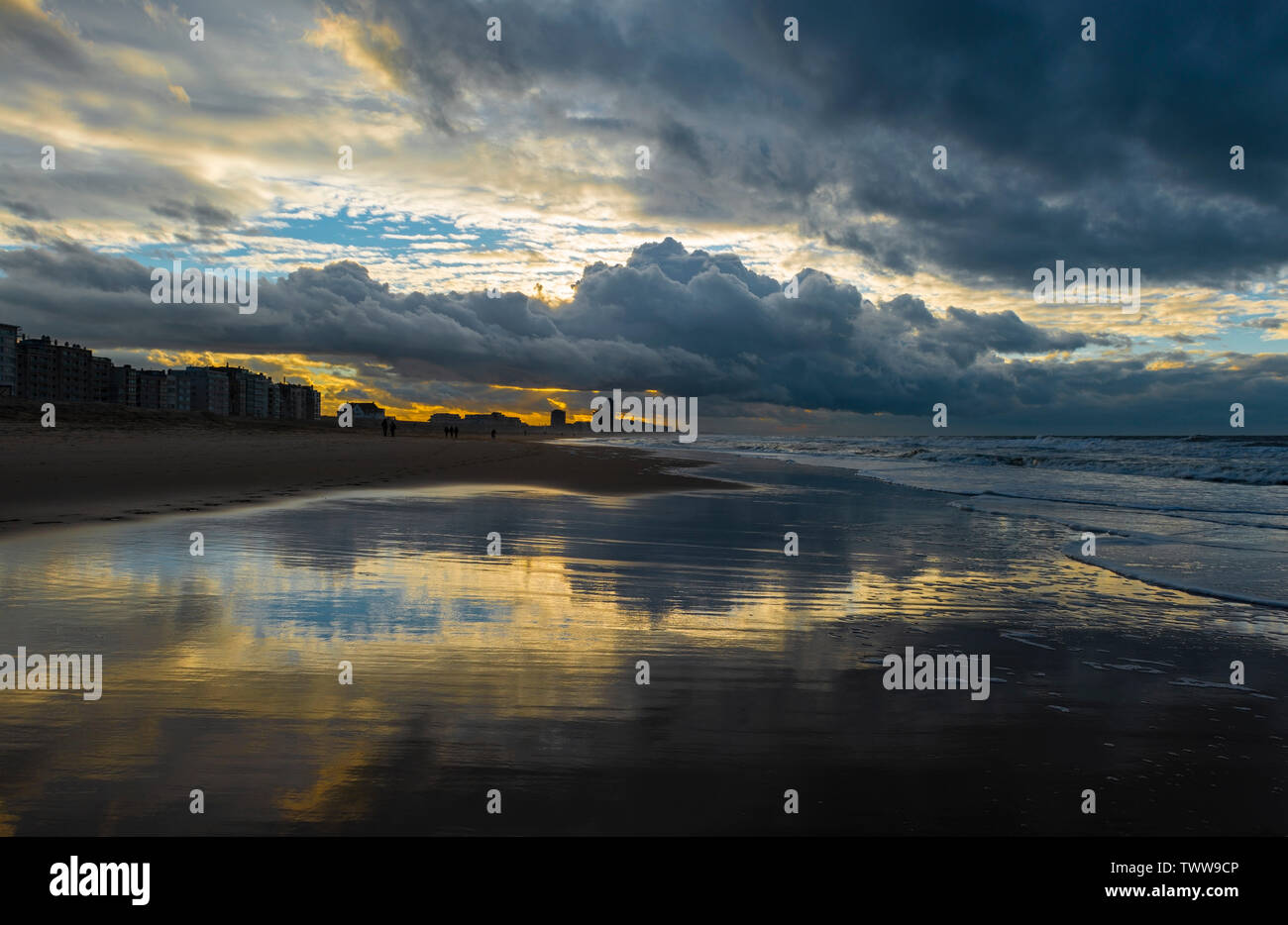 Sunset along the beach of Oostende (Ostend in English) during a thunder storm by the North Sea, West Flanders, Belgium. Stock Photo