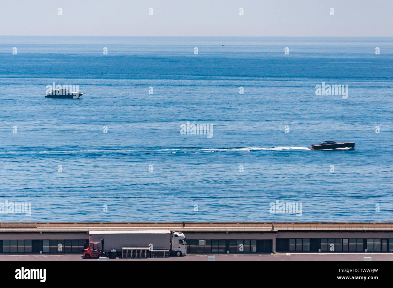 Dock and the sea with speedboats in the Bay of Monaco Stock Photo - Alamy