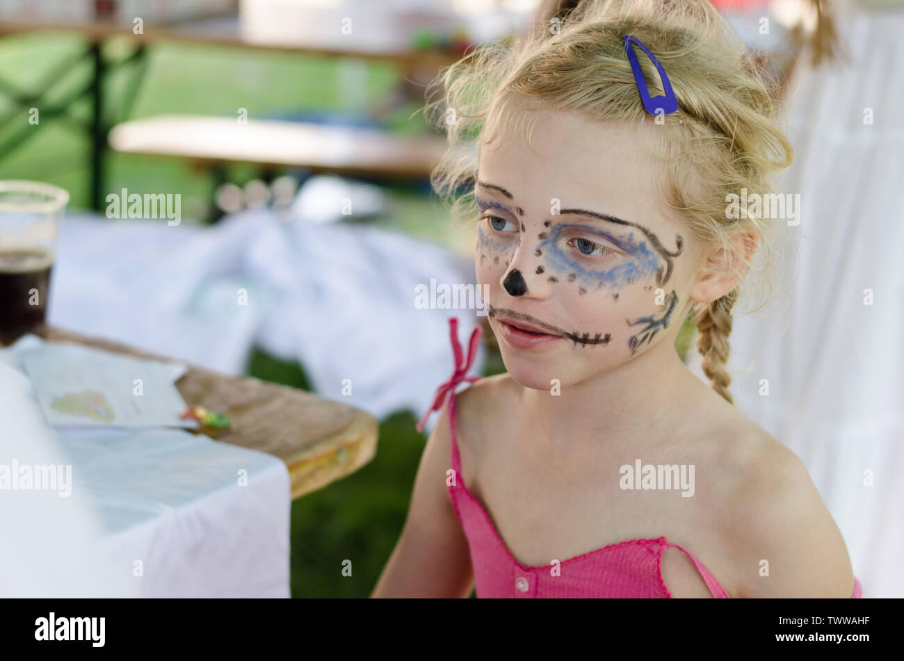 beautiful blond girl with blue monster facepainting Stock Photo Alamy