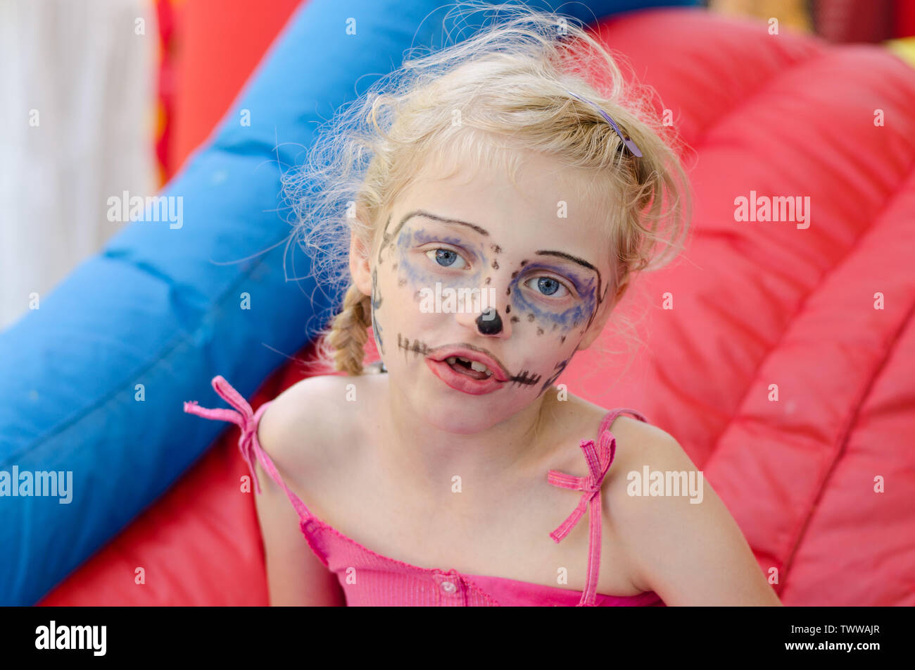 beautiful blond girl with blue monster facepainting Stock Photo Alamy