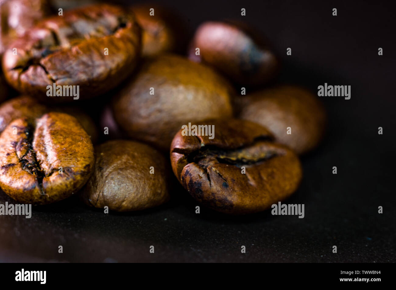 Brown roasted coffee beans on black background, close-up, macro Stock ...