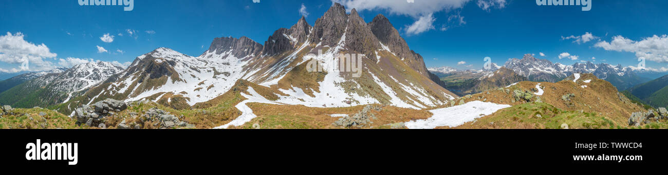 Panoramic view of towering mountain range with scree slopes rising above an alpine plateau. Italian mountains, Dolomites, imposing rock walls and snow Stock Photo