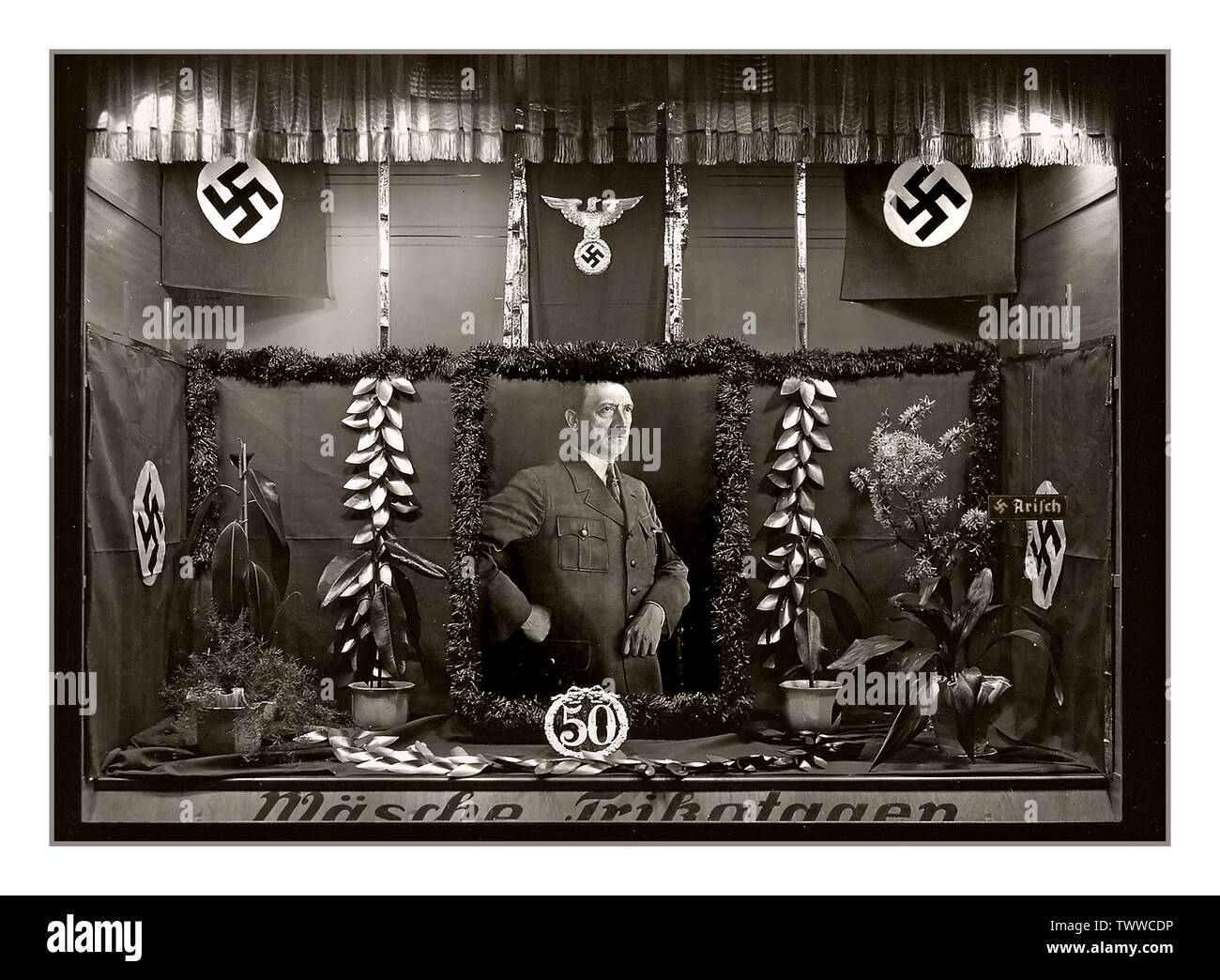 Vintage 1939 Adolf Hitler shop window display celebrating his 50th Birthday On 18 April 1939, the government of Germany declared that their Führer Adolf Hitler's birthday (20 April) was to be a national holiday. Festivities took place in all municipalities throughout the country. Stock Photo