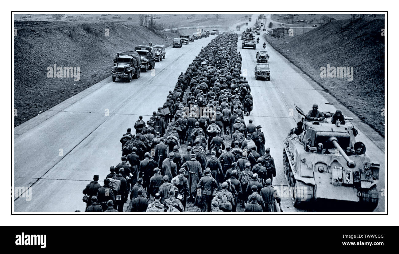 WW2 Mass group of walking Nazi Germany Army prisoners POW’s on German autobahn 04 May 1945, Germany Thousands of German prisoners march along a modern German autobahn superhighway while the American forces push forward in tanks, trucks, and jeeps. May 4, 1945. Stock Photo