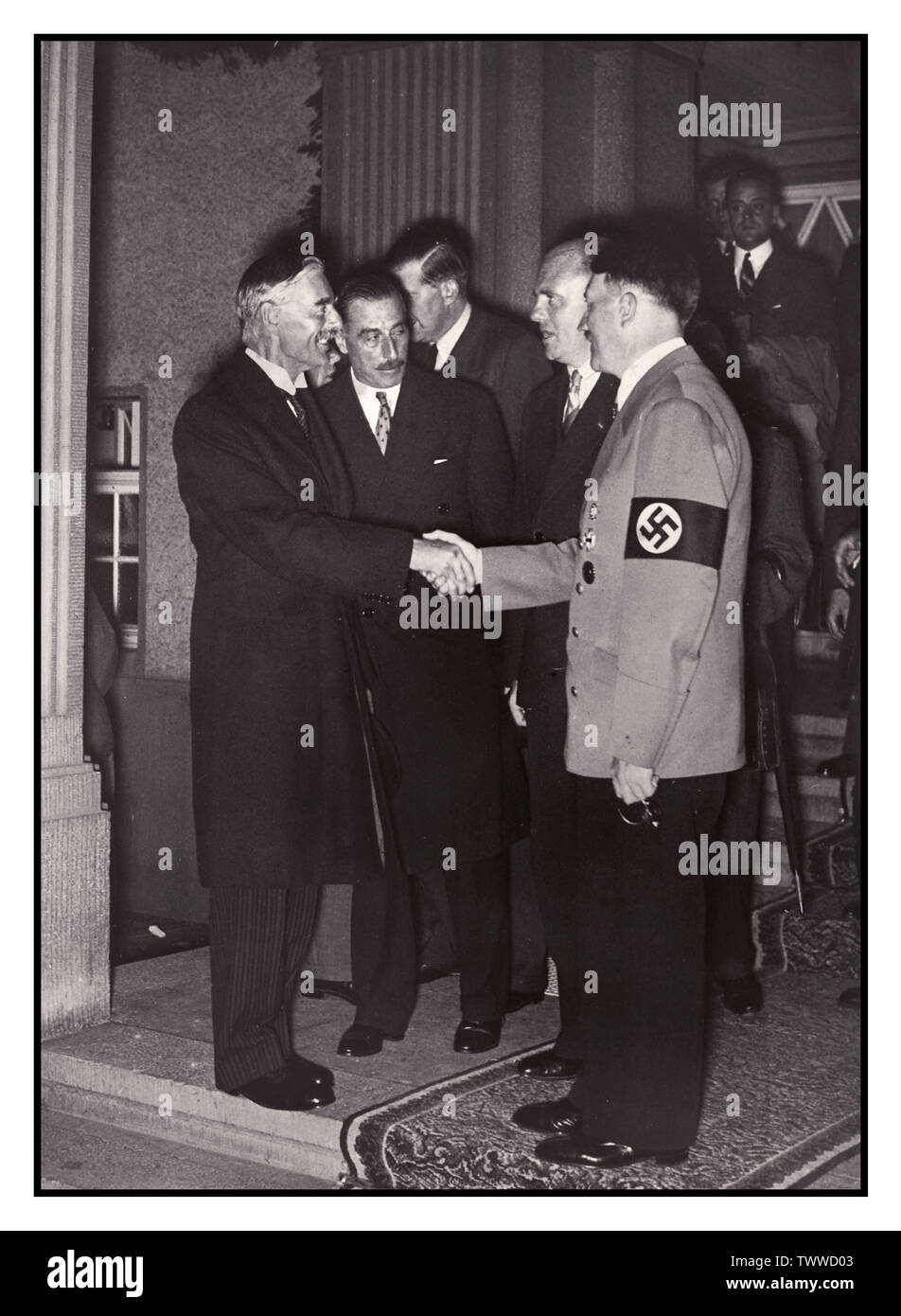 HITLER CHAMBERLAIN Pre-War Propaganda image of Neville Chamberlain British Prime Minister shaking hands and  meeting Adolf Hitler in Berlin Germany 30th September 1938 Stock Photo