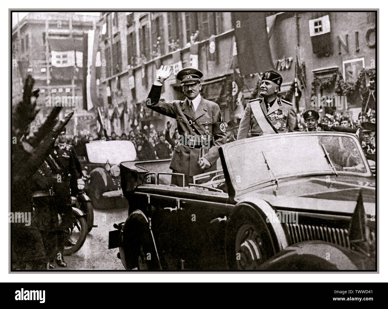 HITLER STATE VISIT ITALY 1938 Adolf Hitler and Benito Mussolini travelling to the Quirinale by car saluting cheering crowds on Corso Rome, Italy, May 8, 1938 Stock Photo