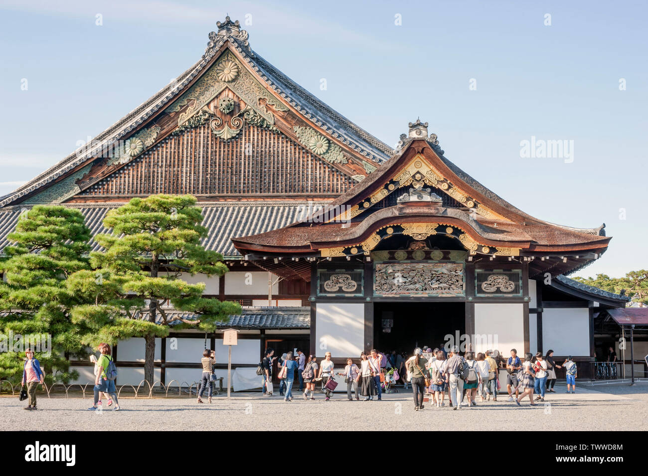 Tourists enter and leave through the entrance door of the Ninomaru Palace, part of the  Nijo castle complex, Kyoto, Japan Stock Photo