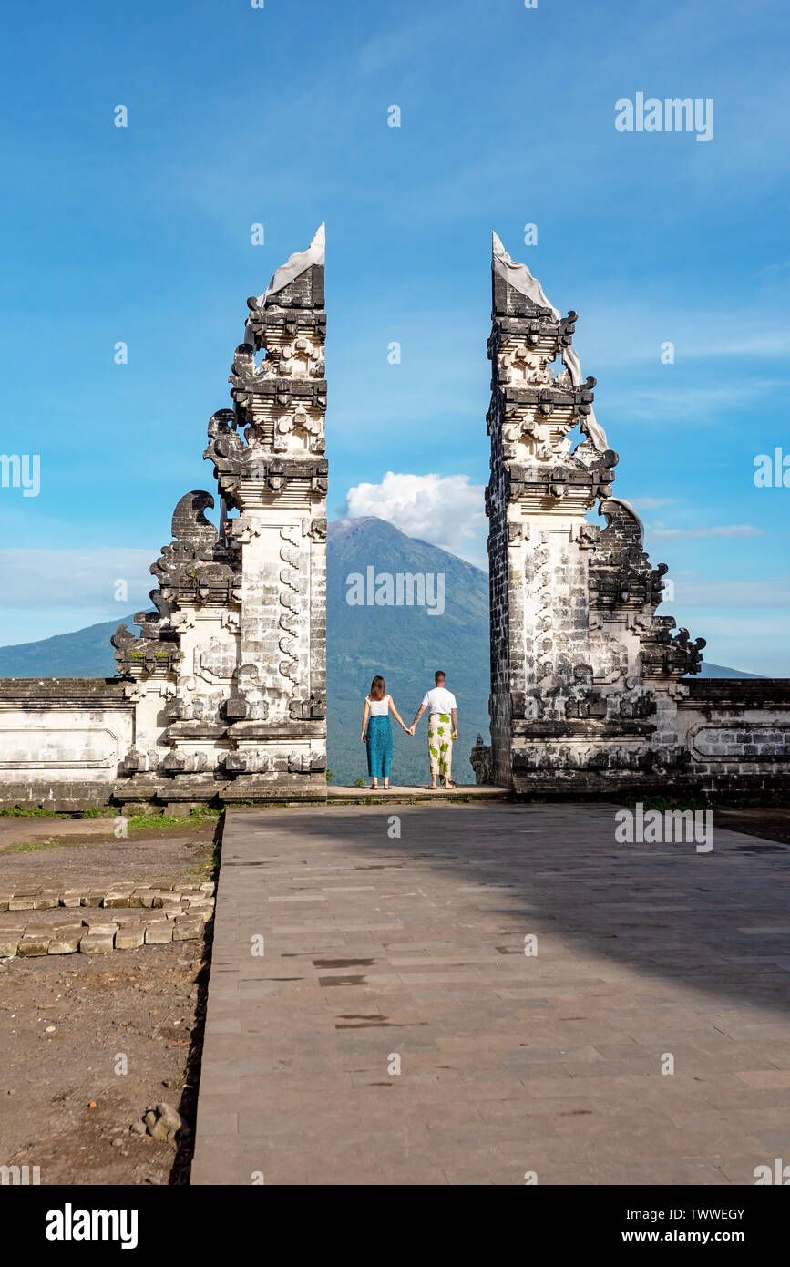 Unidentified Couple at Gate at Pura Lempuyang Luhur with Mr Agung Volcanic View, sacred Hinduism temple in Bali Indonesia. Stock Photo