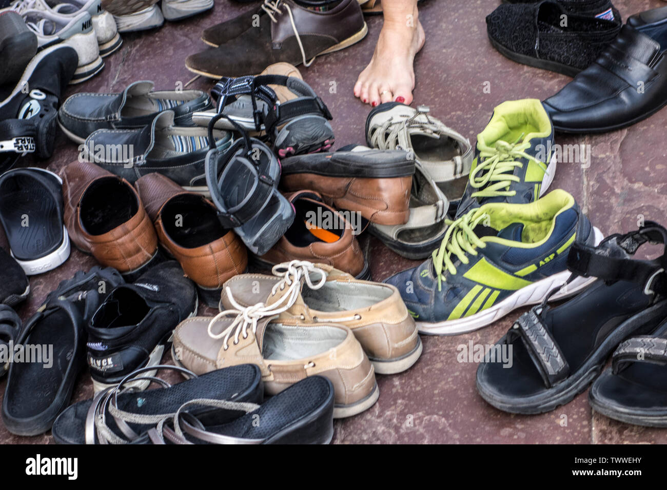 Collection of shoes left outside a mosque in New Delhi, India Stock