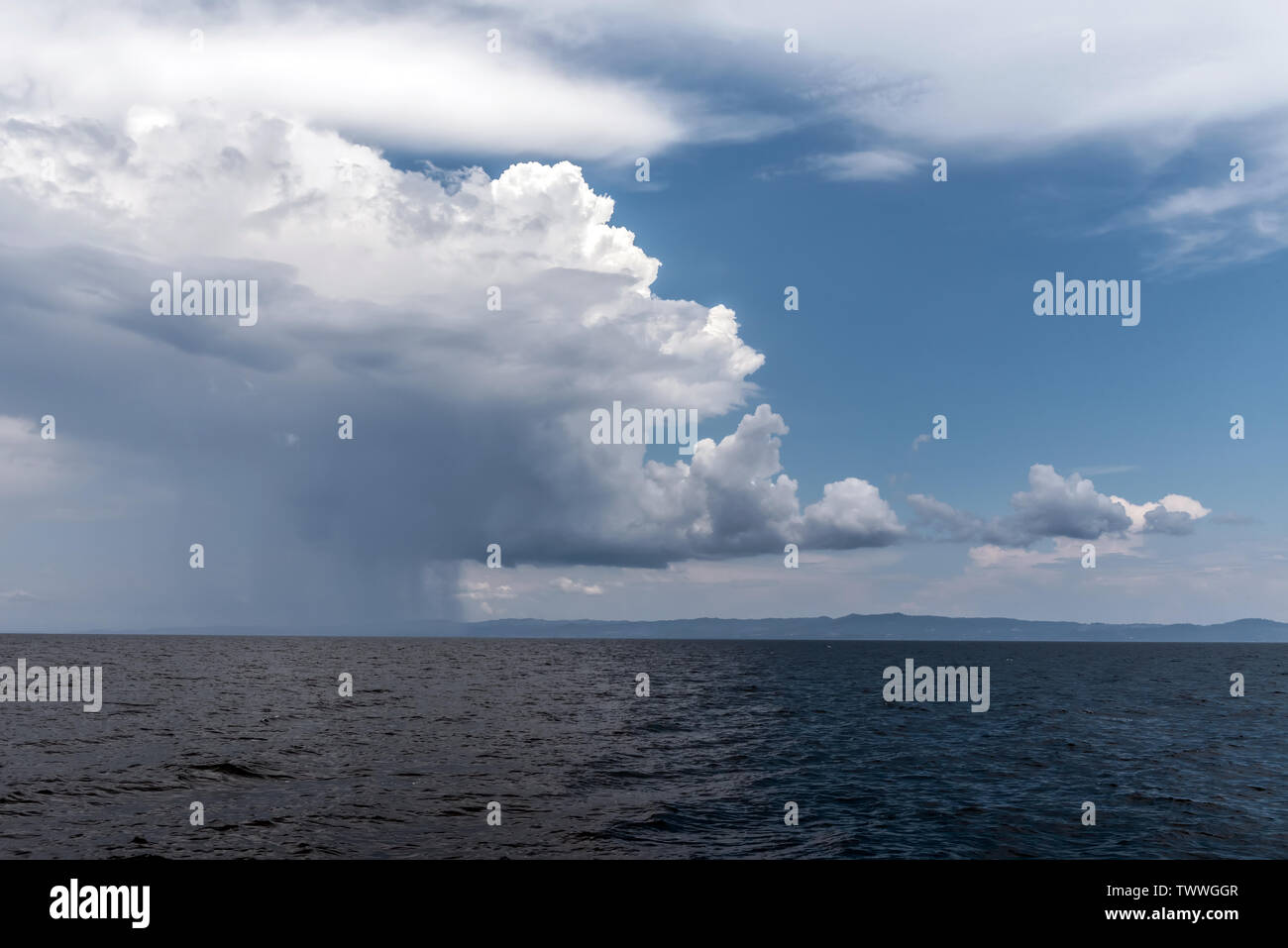 Calm tropical sea under darkening storm storm clouds on the horizon ...