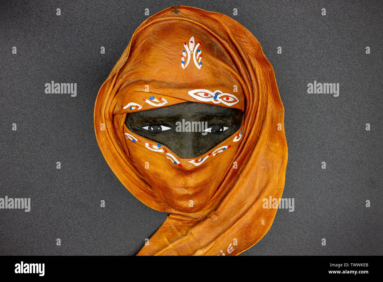 Naples Italy. In the foreground a mask depicting a typical face of a woman with African features and with burqa. Stock Photo