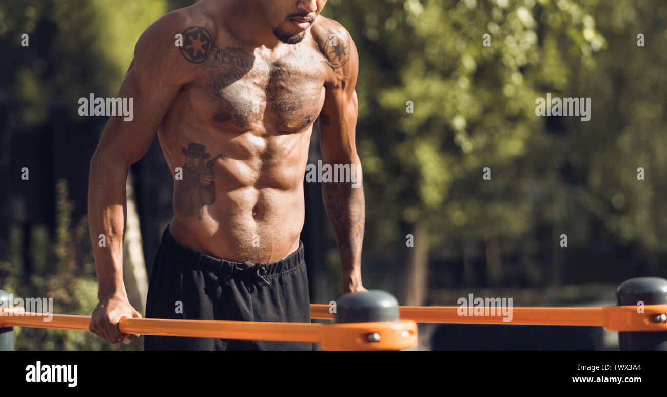 Fit Man Workout Arms On Parallel Bars, Training Triceps Stock Photo - Alamy