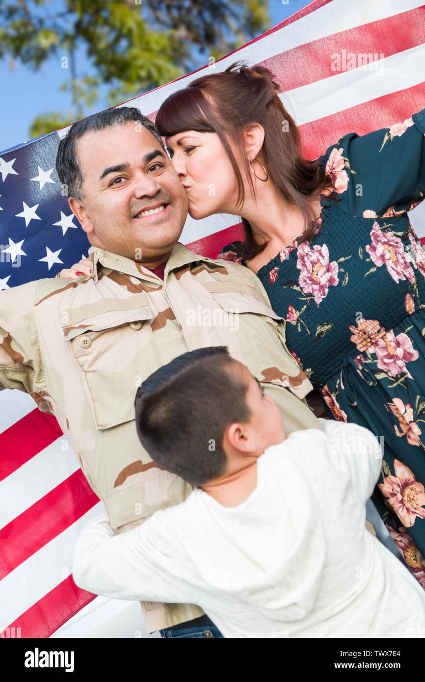 Male Hispanic Armed Forces Soldier Celebrating His Return Holding American Flag. Stock Photo
