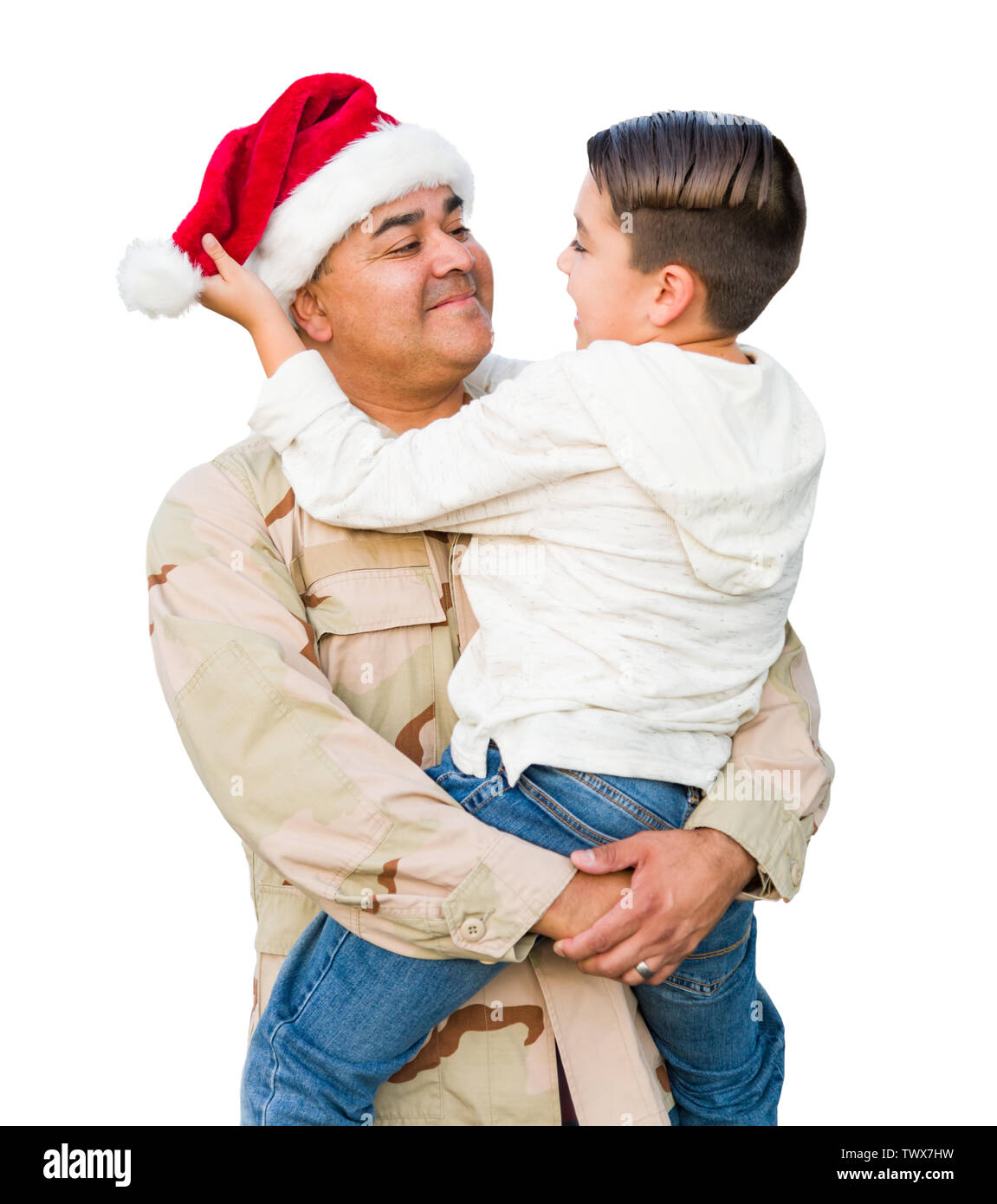 Hispanic Male Soldier Wearing Santa Cap Holding Mixed Race Son Isolated on a White Background. Stock Photo