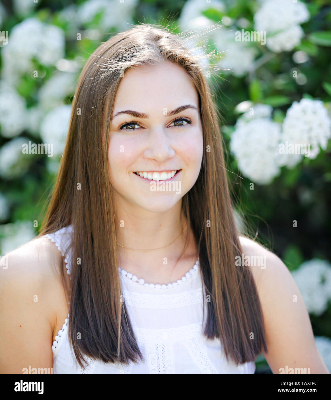 Cute teenage girl with thick long hair. Portrait of Caucasian