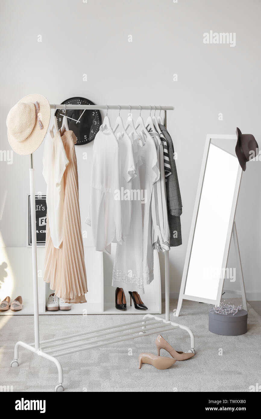 Interior of modern room with clothes rack Stock Photo - Alamy