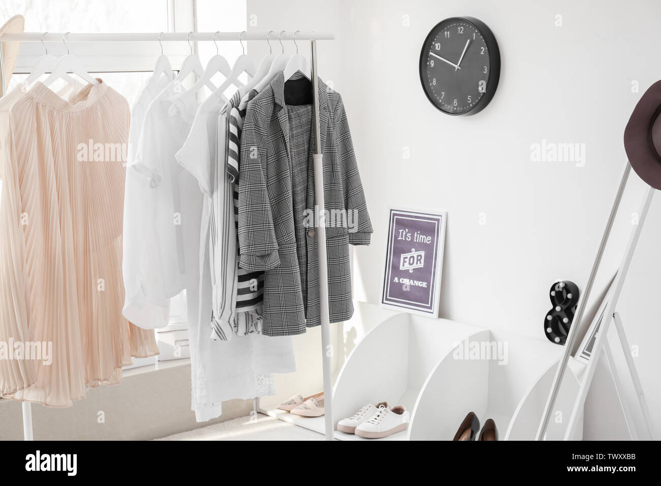Interior of modern room with clothes rack Stock Photo - Alamy