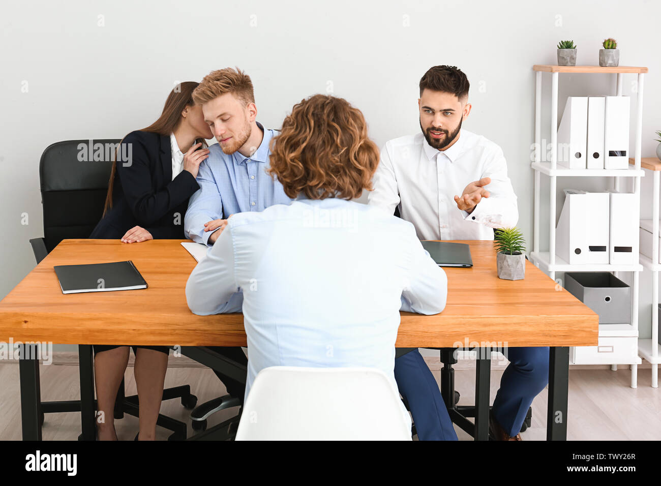 Human resources commission interviewing man in office Stock Photo - Alamy
