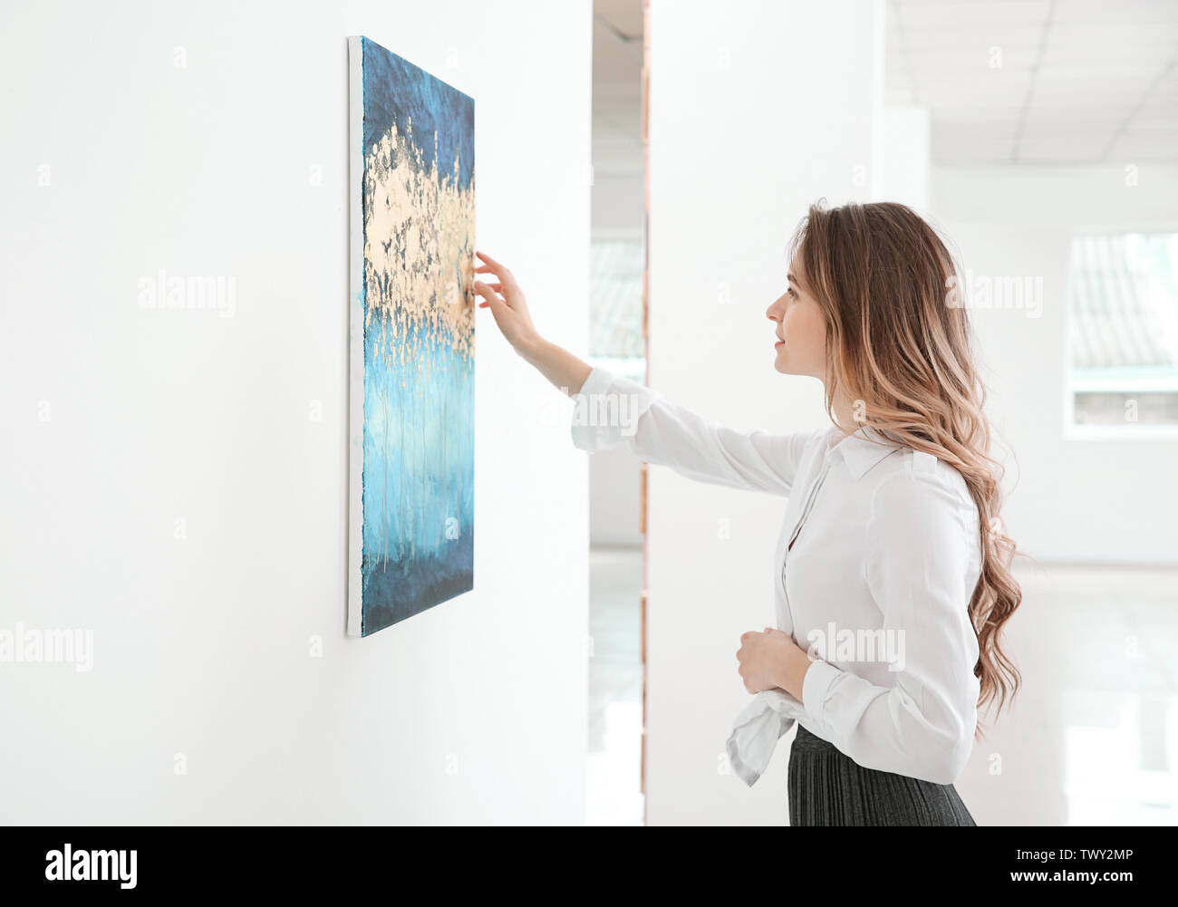 Woman at exhibition in modern art gallery Stock Photo - Alamy