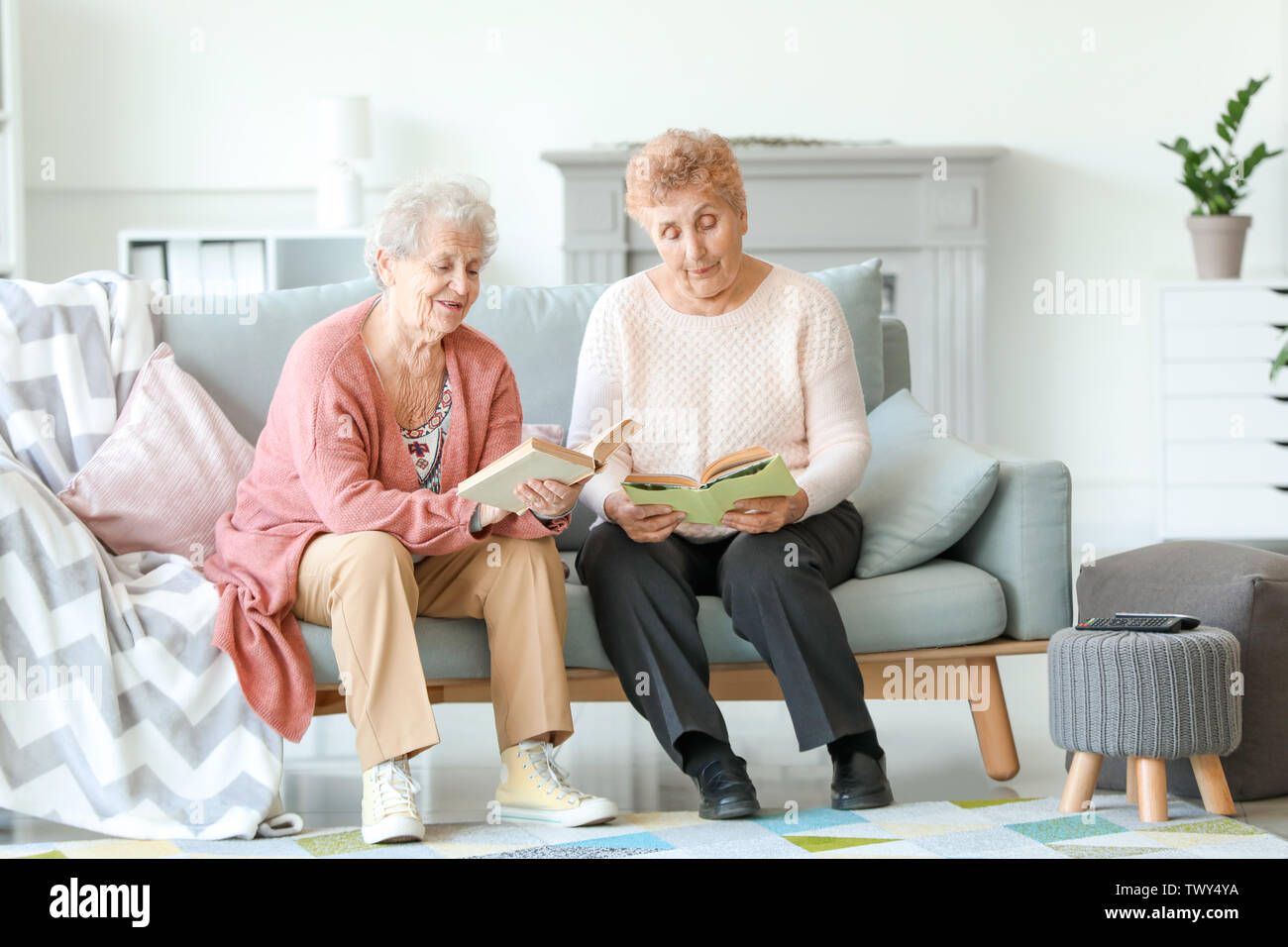 Senior women reading books in nursing home Stock Photo Alamy