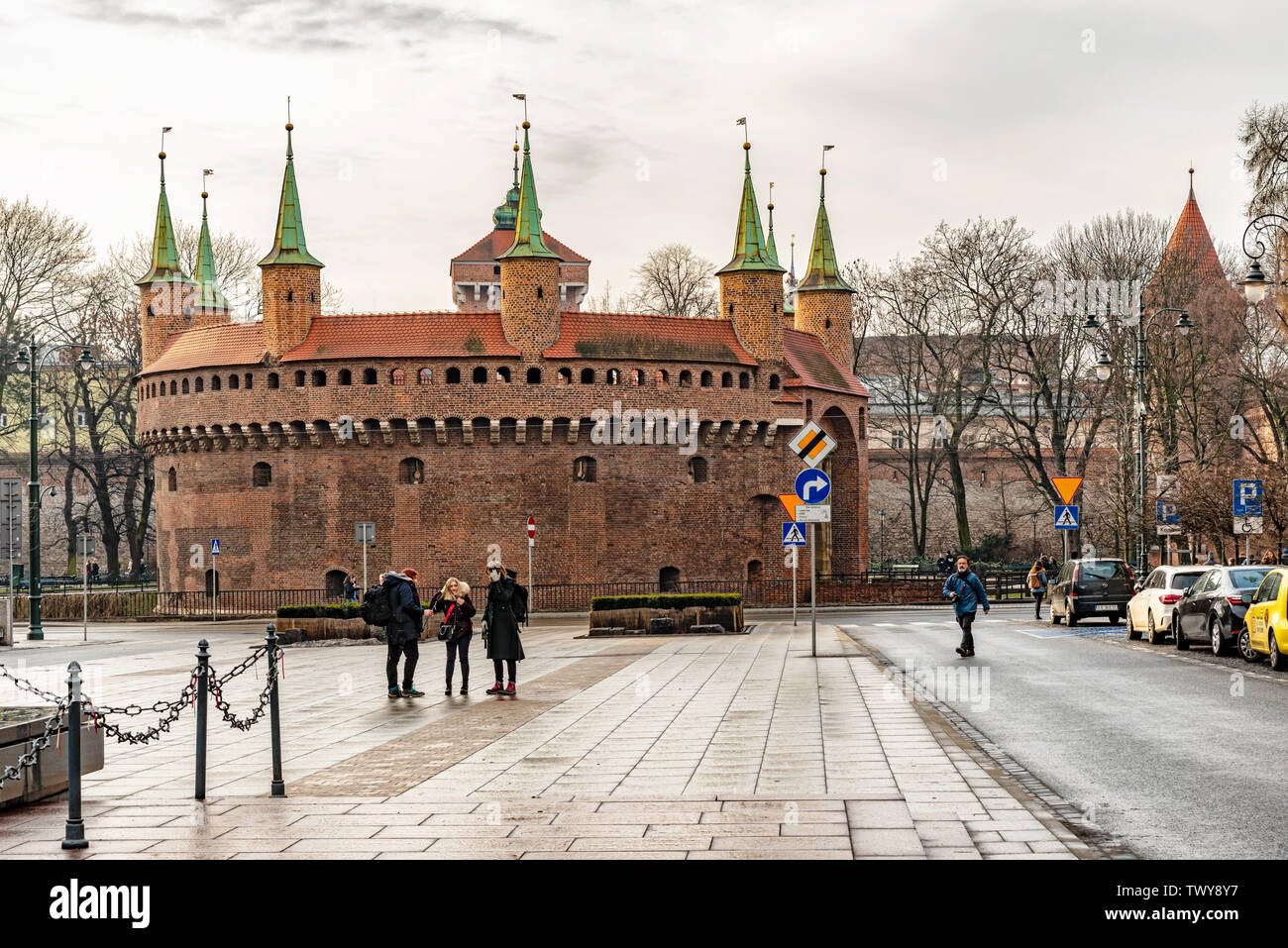 Cracow, Poland – Feb 03, 2019: Tourists visiting Barbican called Barbakan in Cracow, Poland. The best preserved medieval barbican in Europe UNESCO wor Stock Photo