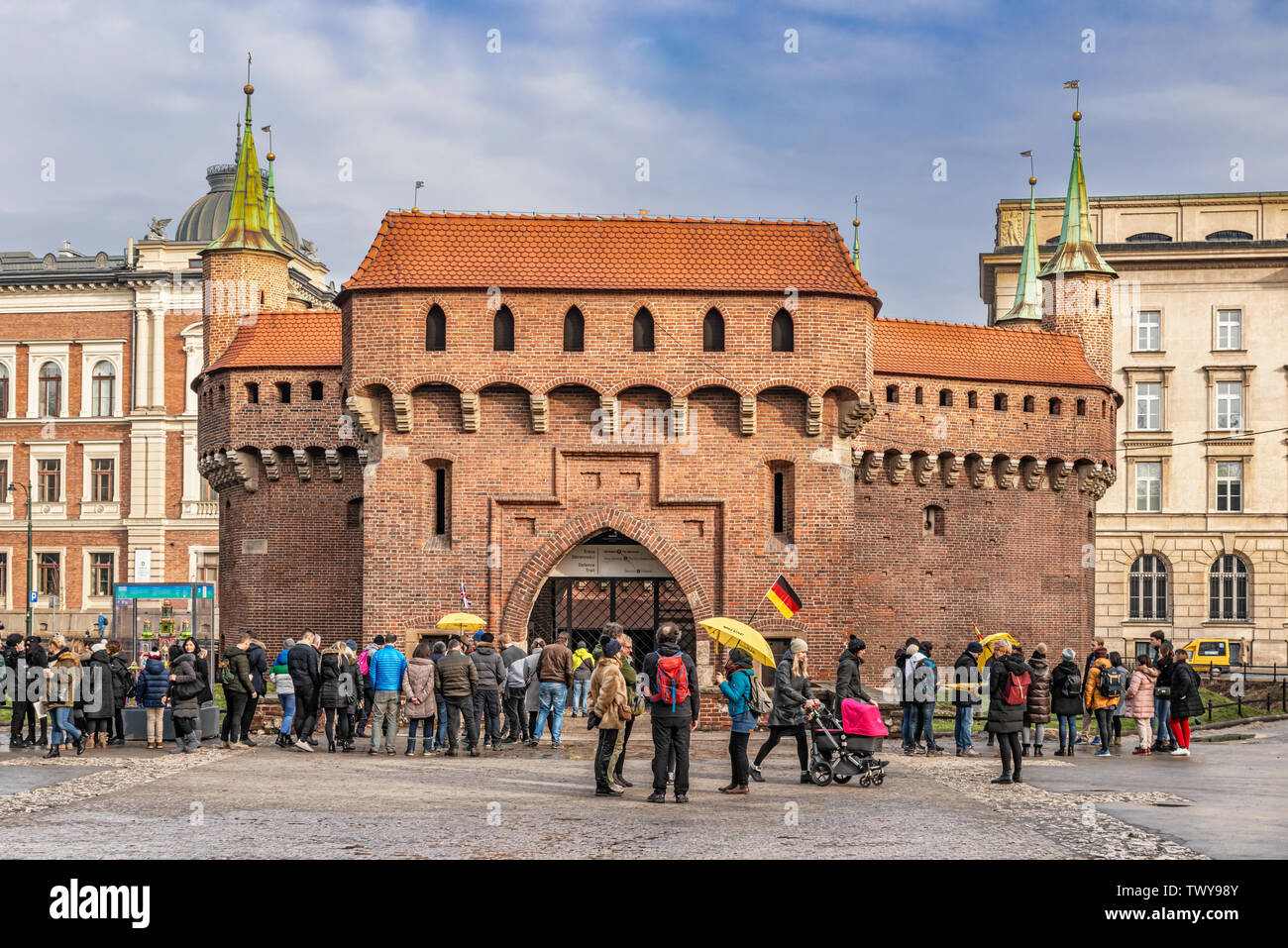 Cracow, Poland – Feb 03, 2019: Tourists visiting Barbican called Barbakan in Cracow, Poland. The best preserved medieval barbican in Europe UNESCO wor Stock Photo