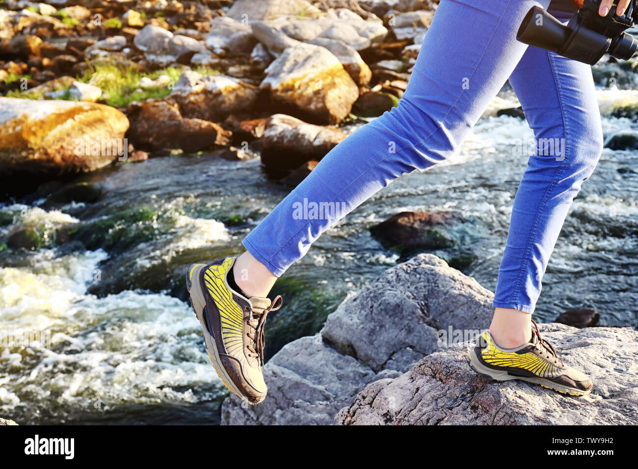 Female tourist walking near mountain stream Stock Photo - Alamy