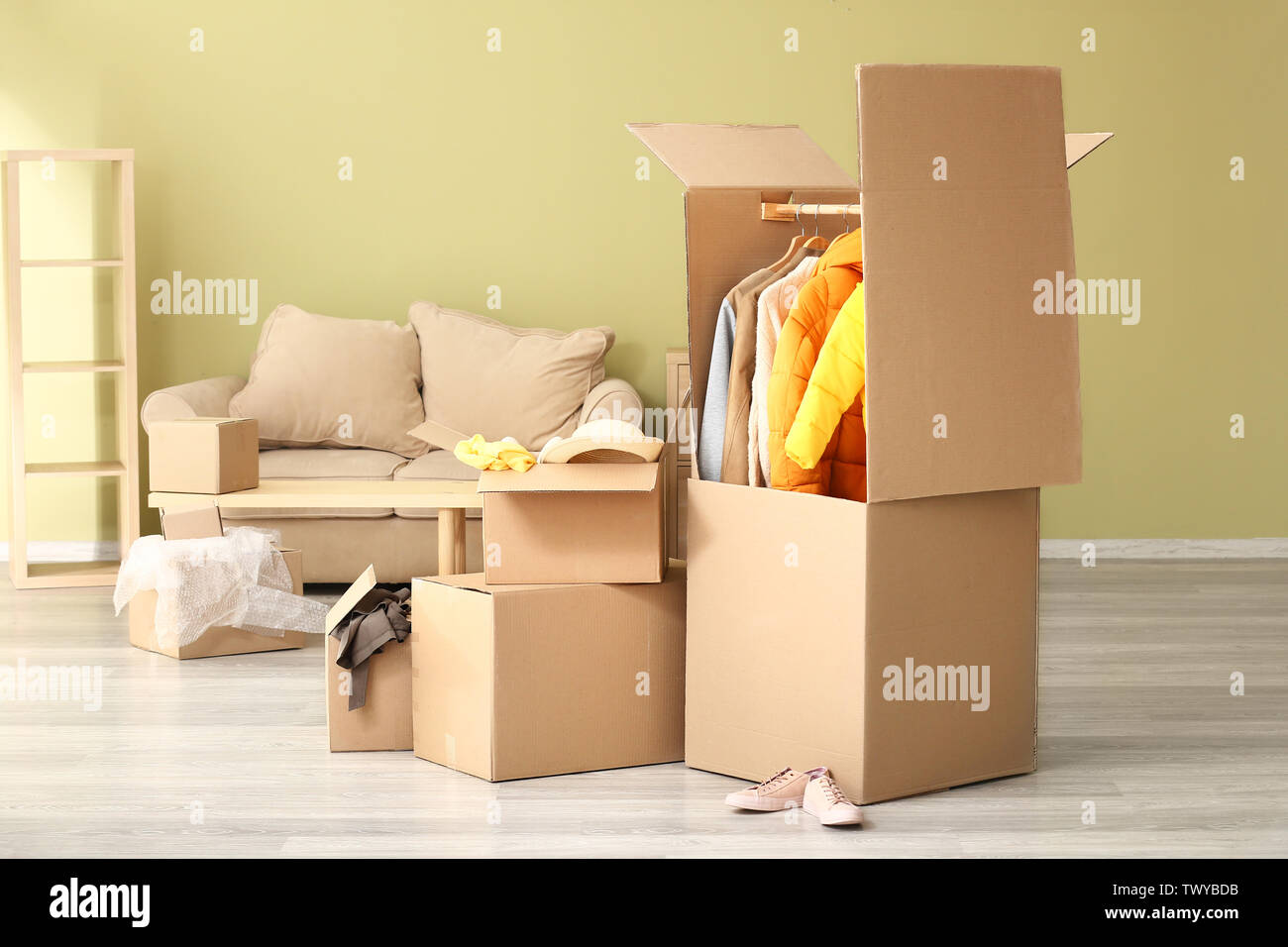 Wardrobe boxes with clothes in room Stock Photo Alamy