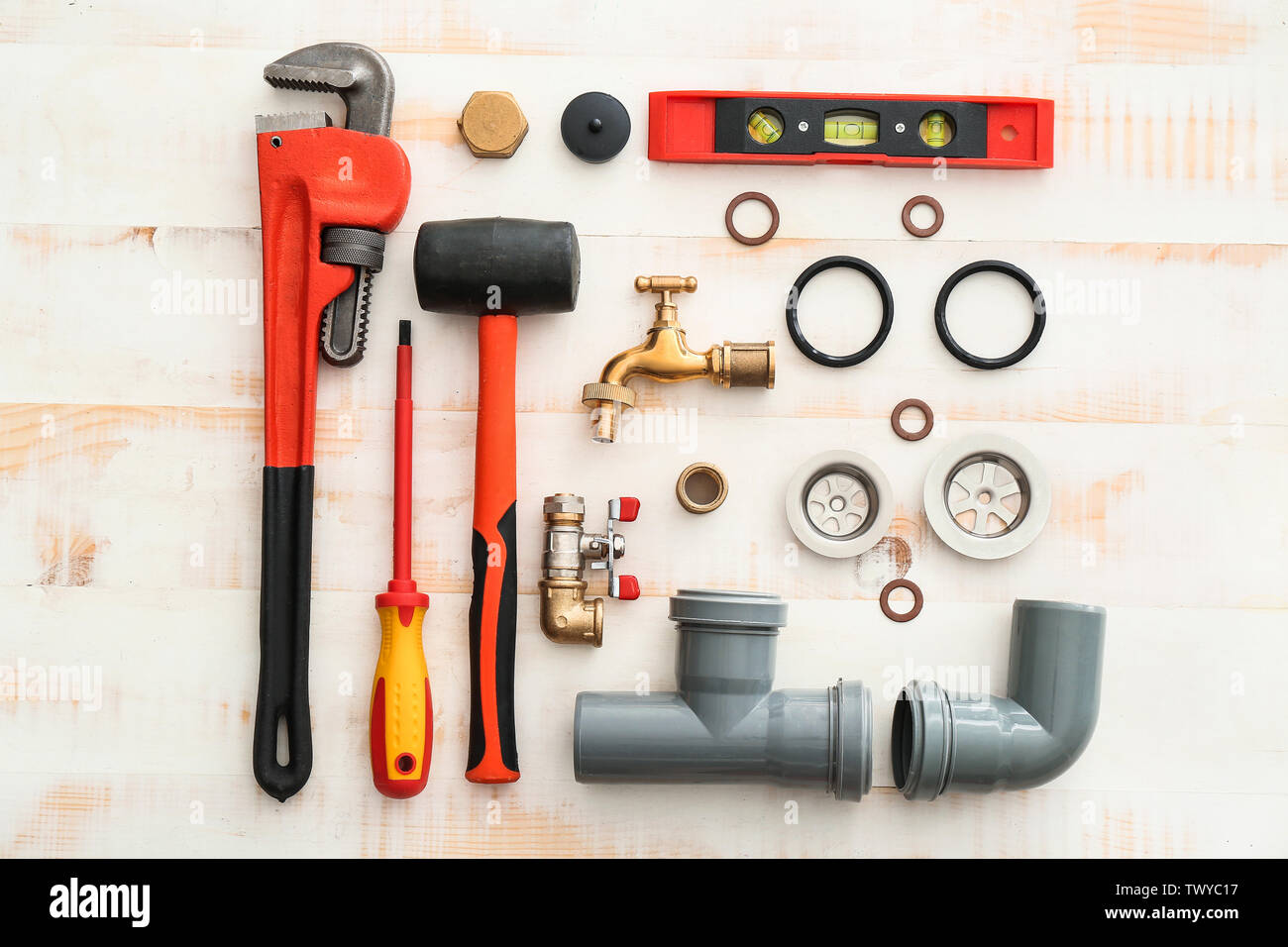 Set of plumbing tools on white wooden background Stock Photo