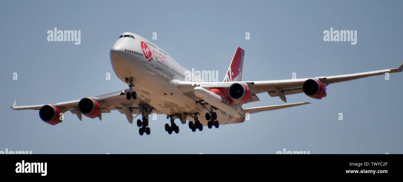 Mojave, California, USA. 23rd June, 2019. Virgin Orbit 747 Cosmic Girl comes in for landing after 4hr test run Sunday morning from Mojave airport California, June 23, 2019. Under it's left wing is the LauncerOne rocket that getting ready for it's first test drop this year. The 747 did a series of test of Zoom Climb Maneuvers off the coast of SoCal and will be leading up to the 1st launch test. Photo by Gene Blevins/ZUMAPRESS Credit: Gene Blevins/ZUMA Wire/Alamy Live News Stock Photo