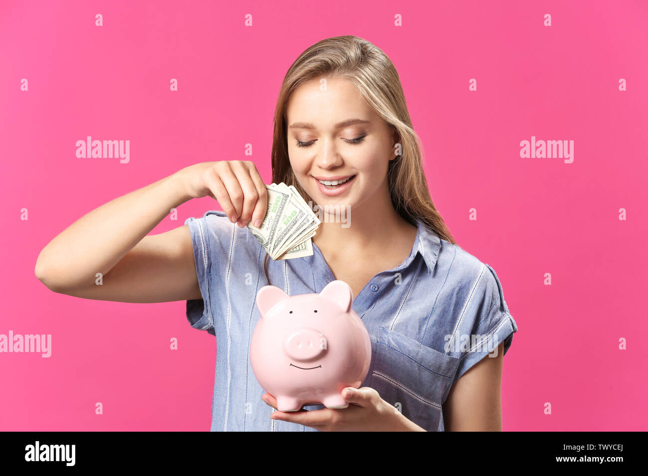 Happy woman with piggy bank and money on color background Stock Photo ...