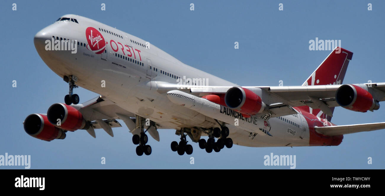 Mojave, California, USA. 23rd June, 2019. Virgin Orbit 747 Cosmic Girl comes in for landing after 4hr test run Sunday morning from Mojave airport California, June 23, 2019. Under it's left wing is the LauncerOne rocket that getting ready for it's first test drop this year. The 747 did a series of test of Zoom Climb Maneuvers off the coast of SoCal and will be leading up to the 1st launch test. Photo by Gene Blevins/ZUMAPRESS Credit: Gene Blevins/ZUMA Wire/Alamy Live News Stock Photo