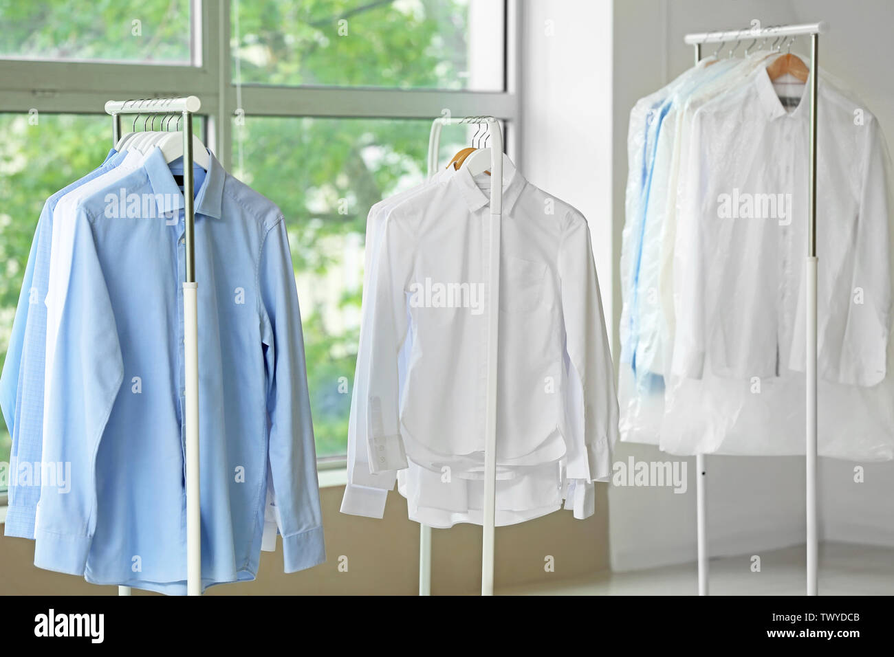 Racks with clothes after drycleaning indoors Stock Photo Alamy