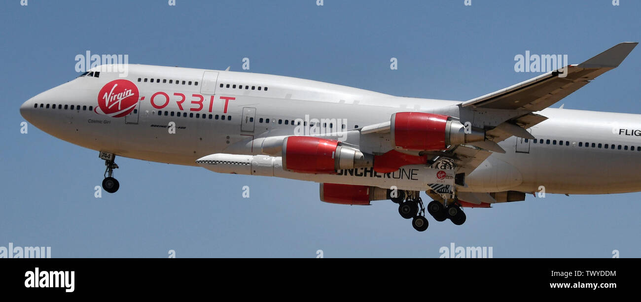 Mojave, California, USA. 23rd June, 2019. Virgin Orbit 747 Cosmic Girl comes in for landing after 4hr test run Sunday morning from Mojave airport California, June 23, 2019. Under it's left wing is the LauncerOne rocket that getting ready for it's first test drop this year. The 747 did a series of test of Zoom Climb Maneuvers off the coast of SoCal and will be leading up to the 1st launch test. Photo by Gene Blevins/ZUMAPRESS Credit: Gene Blevins/ZUMA Wire/Alamy Live News Stock Photo