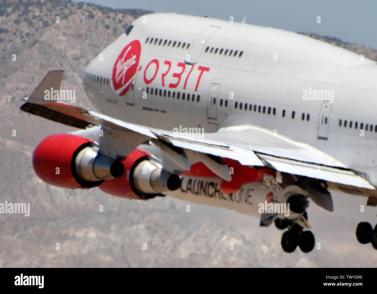 Mojave, California, USA. 23rd June, 2019. Virgin Orbit 747 Cosmic Girl comes in for landing after 4hr test run Sunday morning from Mojave airport California, June 23, 2019. Under it's left wing is the LauncerOne rocket that getting ready for it's first test drop this year. The 747 did a series of test of Zoom Climb Maneuvers off the coast of SoCal and will be leading up to the 1st launch test. Photo by Gene Blevins/ZUMAPRESS Credit: Gene Blevins/ZUMA Wire/Alamy Live News Stock Photo