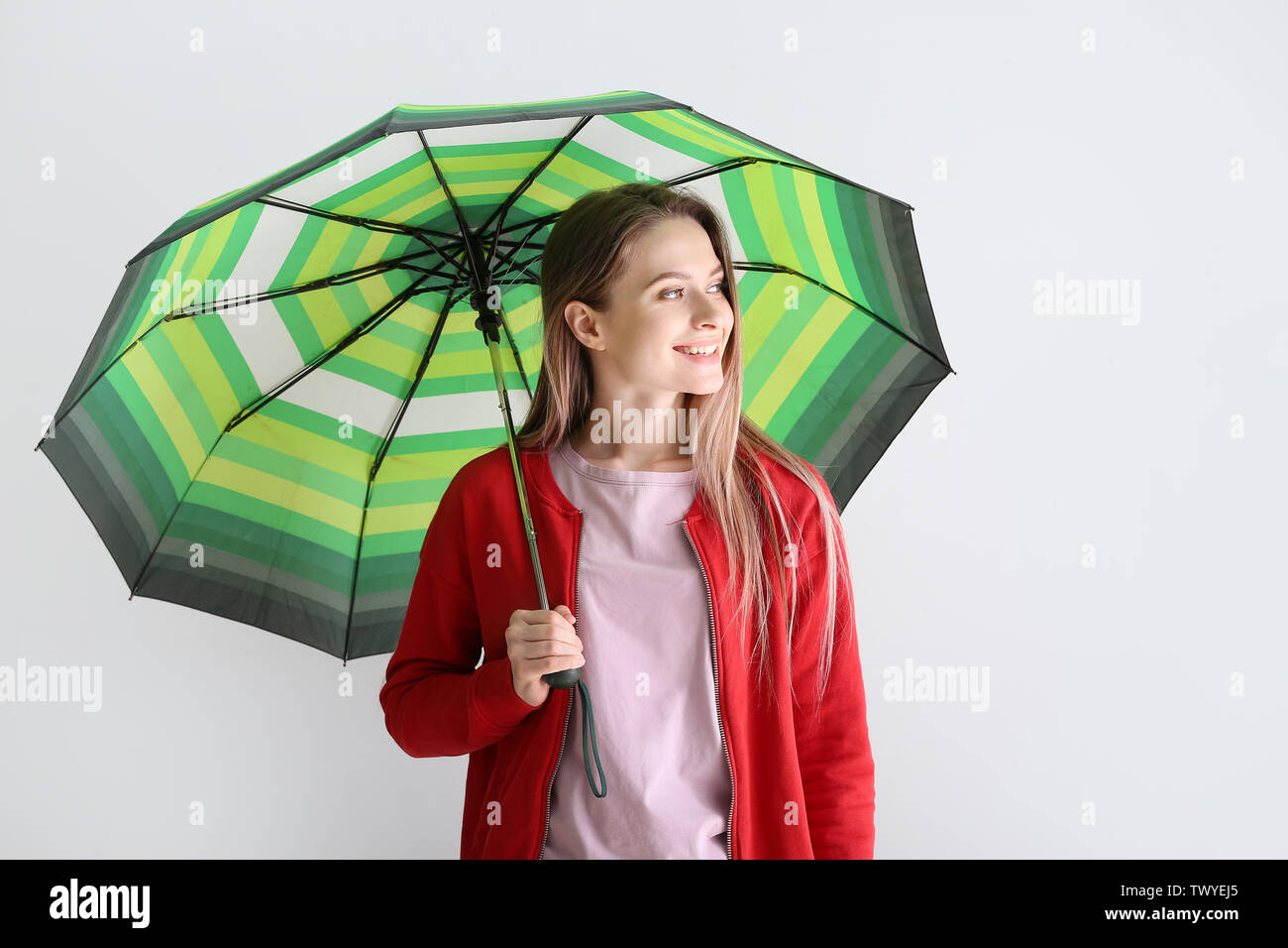 Beautiful young woman with umbrella on white background Stock Photo - Alamy