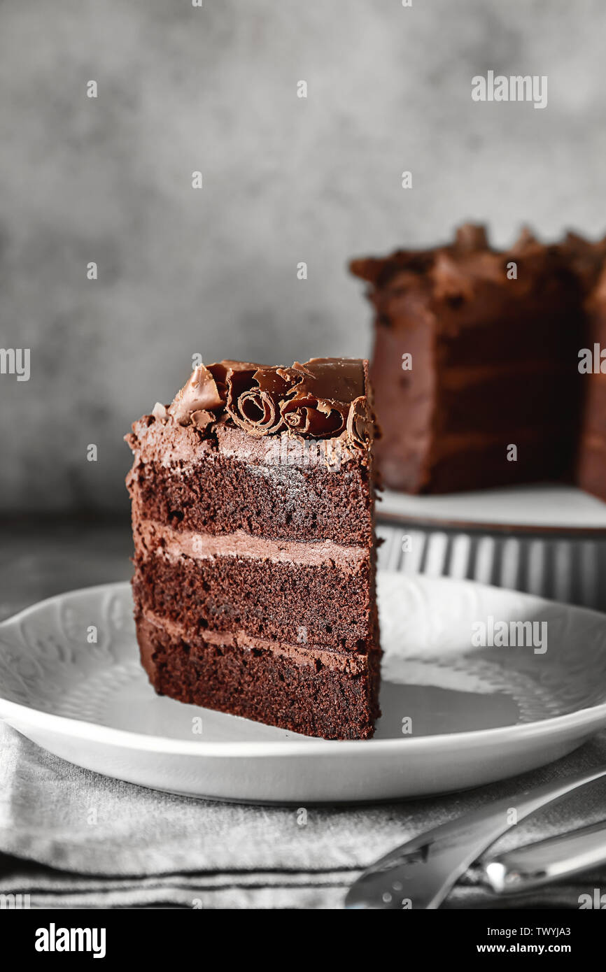 Plate with piece of tasty chocolate cake on table Stock Photo - Alamy