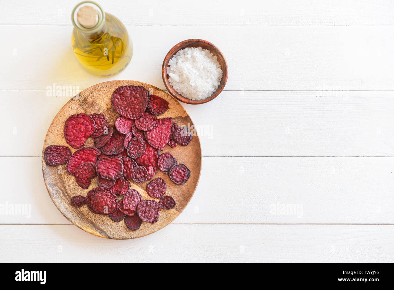 Plate with tasty beet chips on table Stock Photo