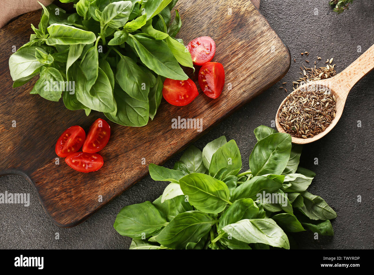 Cutting board with tomatoes, fresh basil and spices on table Stock ...